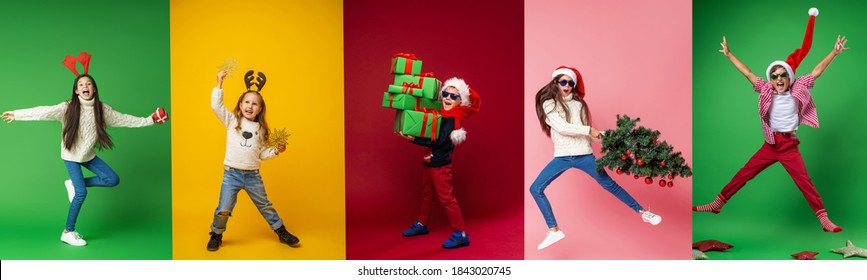 Merry Christmas! Happy Children In Full Growth In A Santa Hat, Reindeer Horns With Gifts, Christmas Tree And Stars On A Multi-color Background, Collage. Green, Yellow, Red, Pink Backgrounds