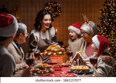  Merry Christmas! Happy Family Are Having Dinner At Home. Celebration Holiday And Togetherness Near Tree.