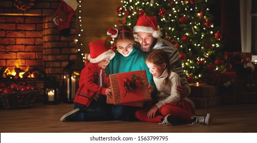 Merry Christmas! happy family mother father and children with magic gift near tree at evening at home
 - Powered by Shutterstock