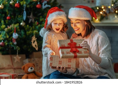 Merry Christmas and Happy Holiday! Loving family mother and child with magic gift box. - Powered by Shutterstock