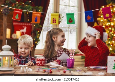 Merry Christmas And Happy Holidays. Adorable Little Children Make Cards, Gifts And Decorations For The Holiday. Cute Kids Are Engaged In Creativity.