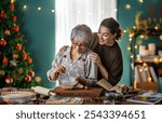 Merry Christmas and Happy Holidays. Family preparation holiday food. Mother and her adult daughter cooking cookies.