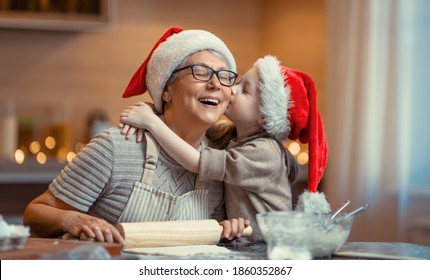 Merry Christmas And Happy Holidays. Family Preparation Holiday Food. Grandma And Granddaughter Cooking Cookies.