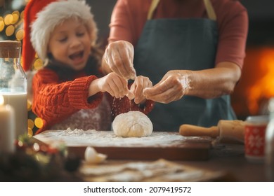 Merry Christmas And Happy Holidays. Family Preparation Holiday Food. Grandma And Granddaughter Cooking Cookies.