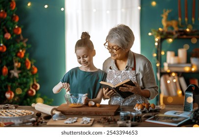 Merry Christmas and Happy Holidays. Family preparation holiday food. Grandmother and granddaughter cooking cookies. - Powered by Shutterstock