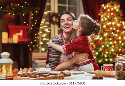 Merry Christmas And Happy Holidays. Family Preparation Holiday Food. Mother And Daughter Cooking Christmas Cookies.