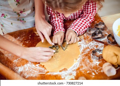 Merry Christmas And Happy Holidays. Family Preparation Holiday Food. Mother And Daughter Cooking Cookies In New Year Interior With Christmas Tree.