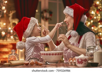 Merry Christmas And Happy Holidays. Family Preparation Holiday Food. Mother And Daughter Cooking Cookies.