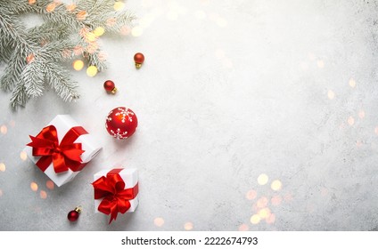 Merry Christmas and Happy Holidays greeting card, frame, banner. New Year. Noel. Christmas white handmade gifts and red decor on light background top view. Winter xmas holiday theme. Flat lay - Shutterstock ID 2222674793