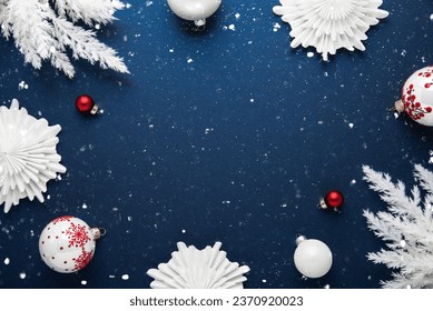 Merry Christmas and Happy Holidays greeting card, frame, banner. New Year. Noel. White Christmas white and red ornaments on blue background top view. Winter holiday xmas theme. Flat lay. - Shutterstock ID 2370920023