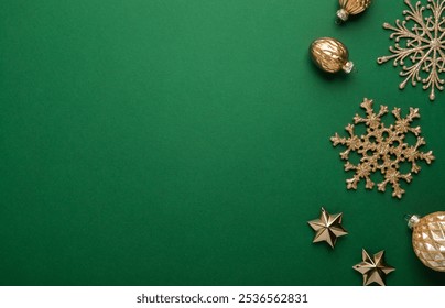 Merry Christmas and Happy Holidays greeting card, frame, banner. New Year. Noel. Golden Christmas ornaments on green background top view. Winter holiday xmas theme. Flat lay. - Powered by Shutterstock