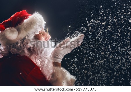 Merry Christmas and happy holidays! Santa Claus blows snow.