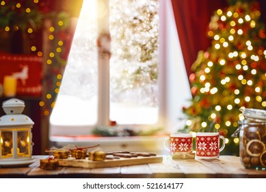 Merry Christmas and Happy Holidays. Time of family tea party. Cups of warm tea with Christmas cookies on wooden table.