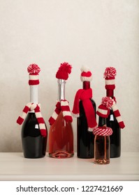 Merry Christmas And Happy New Year! Holiday Knitted Decor - Santa Claus Knitted Hats On The Bottle With Wine. Selective Focus