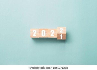 Merry Christmas and happy new year concept, Flipping of wooden cube block change from 2021 to 2022. - Shutterstock ID 1861971238