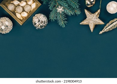 Merry Christmas And Happy New Year Rich Golden And Crystal Baubles Festive Ornaments. Stars Glitter And Christmas Tree Branches With Cones On Teal Green. Party Decor Banner. Top View Border