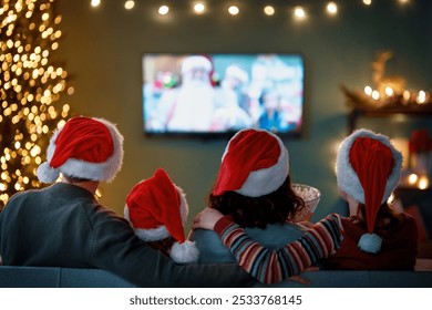 Merry Christmas and Happy New Year. People having fun near tree indoors. Loving family watching holiday movies at home. Mother, father and daughters spending time together. - Powered by Shutterstock