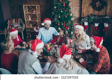 Merry Christmas Large Family Reunion Gathering Meeting Sit Table Have X-mas Feast Father In Santa Claus Hat Cap Joke Mature People Speak Small Little Kids Laugh Wear Reindeer Headband In House