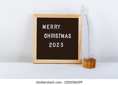 Merry Christmas Lettering On Letter Board. Eco Tree. Minimalistic New Year Background 2023