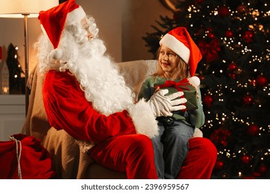 Merry Christmas. Santa Claus giving gift to little girl in room - Powered by Shutterstock