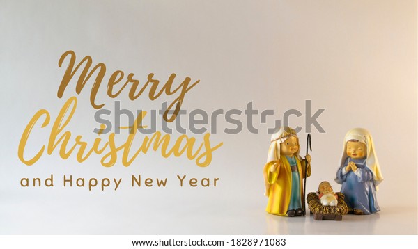 Merry Christmas text with figures of a Bethlehem portal, with Saint Joseph, the Virgin Mary and the baby Jesus