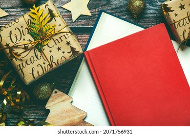 Merry Christmas. Top View Of Books, Christmas Gifts And Christmas Decorations On Wooden Table. Christmas Concept Background