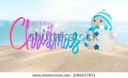 Merry Christmas.Handwriting and Snowman on the sand beach.