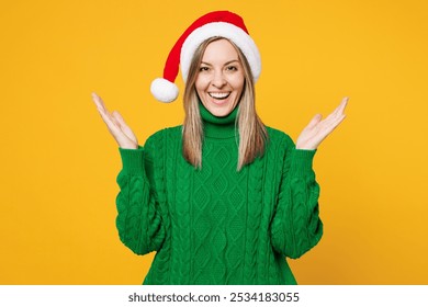 Merry shocked surprised young woman wears green warm cozy sweater Santa hat posing look camera spread hands isolated on plain yellow background. Happy New Year celebration Christmas holiday concept - Powered by Shutterstock