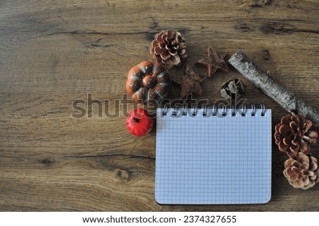 MerryChristmas background - empty notebook on the wooden background next to natural christmas deco