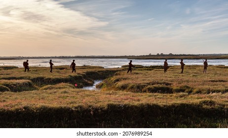 Mersea Island, UK - October 27, 2019 - Silhouettes of metal WW1 soldiers march across the landscape. A touching remembrance tribute to the men who lost their lives in WW1.