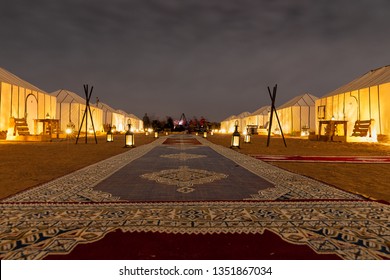 Merzouga / Morocco - February 19 2019: 
People Gathered Around The Fire In Golden Camp Site In Sahara Desert (Merzouga), Morocco During Night Time