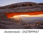 Mesa arch at dawn looking towards washerwoman arch, islands in the sky section of canyonlands national park, utah, united states of america, north america