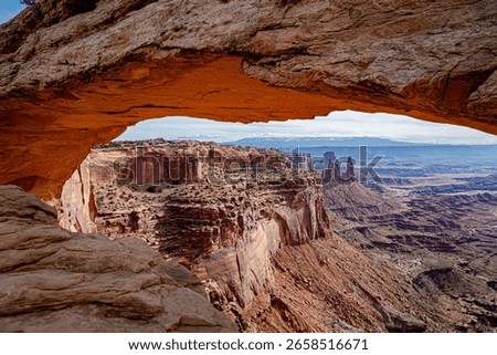 Mesa Arch frames the breathtaking view of Canyonlands National Park, USA, showcasing dramatic red rock formations and deep canyons under soft natural light—captured using landscape photography