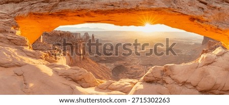 Mesa Arch is a pothole arch on the eastern edge of the Island in the Sky mesa in Canyonlands National Park, San Juan County, Utah, United States. Sunrise in summer time. Popular destination.