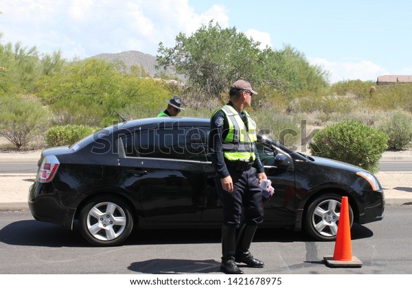 Mesa, Ariz. / US - September 6, 2010: During a\
joint Labor Day sobriety checkpoint operation, police officers from\
Mesa and Gilbert talk to drivers about the dangers of driving under\
the influence.