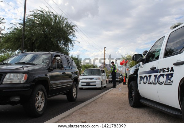 Mesa, Ariz. / US - September 6, 2010: During a joint\
Labor Day sobriety checkpoint operation, Mesa and Gilbert police\
officers talk to drivers about the dangers of driving under the\
influence. 7928