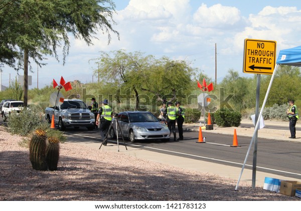 Mesa, Ariz. / US - September 6, 2010: During a joint\
Labor Day sobriety checkpoint operation, Mesa and Gilbert police\
officers talk to drivers about the dangers of driving under the\
influence. 7855