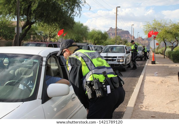 Mesa, Ariz. / US - September 6, 2010: During a joint\
Labor Day sobriety checkpoint operation, Mesa and Gilbert police\
officers talk to drivers about the dangers of driving under the\
influence. 7924