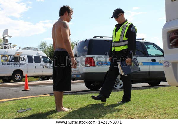 Mesa, Ariz. / US - September 6, 2010: To check their\
sobriety, Mesa and Gilbert police officers ask drivers suspected of\
being intoxicated to walk a straight line during a joint Labor Day\
event. 7840