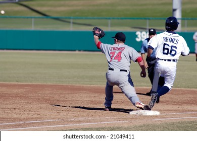 MESA, AZ - NOV 20: Will Rhymes Of The Mesa Solar Sox Beats Throw To Scottsdale Scorpions First Baseman Mark Trumbo In The Arizona Fall League Game On November 20, 2008 In Mesa, Arizona