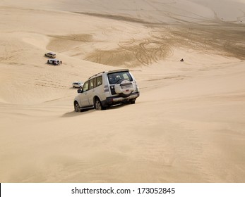 MESAIEED, QATAR - JANUARY 10, 2014: 4WD Driving On A Sand Dune In The Desert, Called Dune Bashing, In The South Of Qatar.