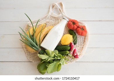 Mesh bag with fruit and vegetables, fortification. Replacing plastic bags. Taking care of the environment.  Zero waste home. Copy space. Top view. - Shutterstock ID 1724110417