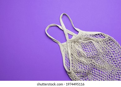 Mesh Bag On A Bright Purple Background. Vintage Grocery Bag. Flat Lay.