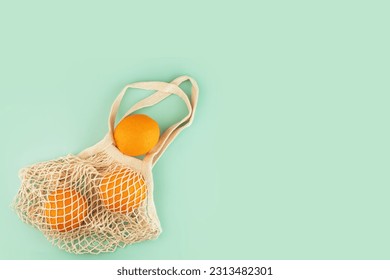 mesh bag with oranges, string bag on a natural background, copy space - Powered by Shutterstock