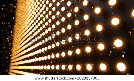 A mesmerizing abstract background featuring a dense grid of glowing golden lights receding into the distance, creating a tunnel-like perspective.
