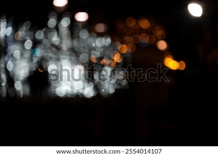 A mesmerizing abstract display of blurred lights in various colors, creating a whimsical night scene.