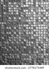 Mesmerizing abstract mosaic pattern featuring square metallic tile in shiny silver color providing hypnotic texture and sophisticated background for modern decoration and creative design projects