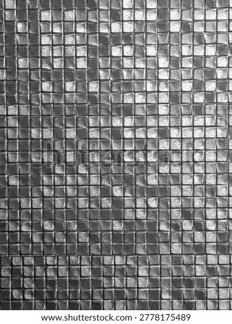 Mesmerizing abstract mosaic pattern featuring square metallic tile in shiny silver color providing hypnotic texture and sophisticated background for modern decoration and creative design projects