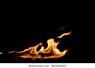 A mesmerizing display of dancing flames against a pitch-black background, showcasing vibrant colors and dynamic movement, perfect for evoking warmth and energy.