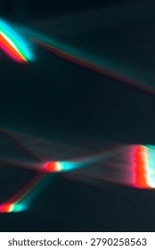 A mesmerizing display of intersecting light beams in shades of red, green, and blue against a dark background, creating a dynamic and futuristic visual effect with glowing lines.